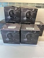 Six boxed night light projectors stacked together showing the packaging and product images.