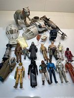 Wide overview of figures, Tauntaun creature and Falcon hull parts