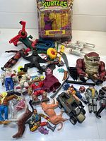 Full view of all loose toys and boxed Splinter figure displayed on white surface showing a variety of action figures and toys