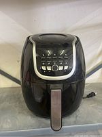 Front view showing control buttons and handle of PowerXL air fryer.