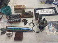 Various miscellaneous home decor items including pots, cigar boxes, painted driftwood, Tiffany style lamp, metal art, and more.