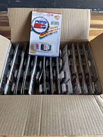 Box opened showing rows of individually packaged Pepsi Golden Wheel toy cars from 1997, all still on their cards.