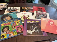 Photo of vinyl LP albums including The Partridge Family, Hank Williams, Helen Reddy, Star Trek 3, West Side Story, and others on a table.