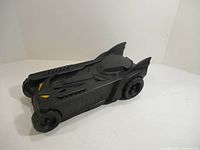 Black plastic Batmobile toy car angled view showing front and side details
