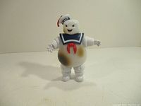 Full body image of the Stay Puft Marshmallow Man figure with visible brown stains on the torso.