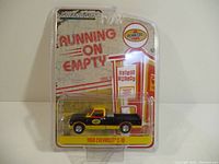 Overview of Greenlight 1968 Chevrolet C-10 diecast truck in sealed packaging, showing front and side of box
