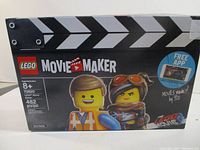 Front view of the LEGO Movie Maker set 70820 box showing brand, piece count, recommended age, and two LEGO characters.