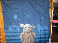 Comforter side with large Grogu image and starry space background with Star Wars vehicle silhouettes