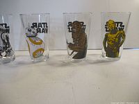 Four Star Wars pint glasses featuring Chewbacca, BB-8, and C-3PO characters, all visible with Star Wars logos on each glass.