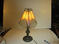 Full view of the vintage table lamp with stained glass shade illuminated
