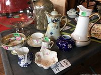 Photo showing set of hand-painted and Limoges china items on table