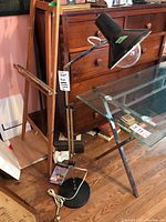 Full view of the MCM floor lamp showing the chrome arm, black conical shade with clear globe bulb cover, and round base with white power cord.