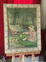Full view of framed litho print showing child feeding chicks by pond with trees and countryside background.