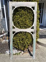 Front view of the wood farmhouse porch door showing the two circular cutouts and rustic distressed paint with heart shapes at corners.