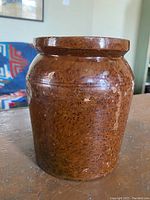 Front-side view of the brown pepper flaked crock showing surface texture and shape.