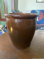 Front and side views of early Southwest Ontario open redware crock showing height, shape and glaze condition with faint crazing lines visible.