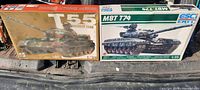 Boxes of the two tank model kits, T55 Medium Tank and MBT T74, showing front artwork and scale details.