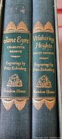 Spines of the two hardcover books Jane Eyre and Wuthering Heights with gold embossing and text noting engravings by Fritz Eichenberg, publisher Random House.