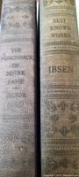 Photo showing spines of both books with titles clearly visible: The Hunchback of Notre Dame by Victor Hugo and Best Known Works Ibsen.