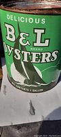 Close-up of green side of the antique oyster can showing B&L brand and oyster graphic.