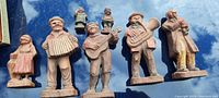 Photo of six carved wooden figures playing musical instruments, showing full front view and allowing size and detail assessment