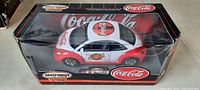 Front view of the Volkswagen Beetle diecast model in original packaging showing Coca Cola branding and Matchbox collectibles label.