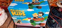 Original boxed Flintstones Kids Bedrock Airlines prehistoric airplane playset showing airplane with Fred and Wilma Flintstone figures riding in a dinosaur-shaped green airplane toy with a bird at front.