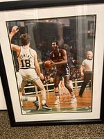 Full view of framed autographed photo showing Elvin Hayes playing basketball, with autograph visible on the lower right.