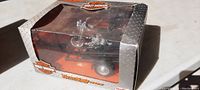 Boxed Harley Davidson motorcycle die cast toy on trailer with foggy box window