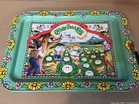 Full view of the metal tray showing colorful Cabbage Patch Kids artwork and floral border.