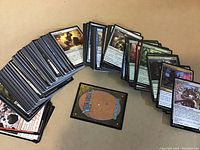 Multiple stacks of Magic the Gathering cards, showing front and back sides.