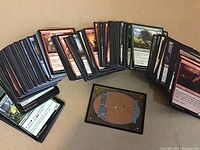 Spread of approximately 220 Magic the Gathering cards showing front face with artwork and text.