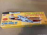 Box top showing the Guillow's brand and P-40 Warhawk model kit with a Sharpie marker for size reference.