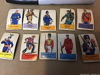 Photo showing all 10 small woven textile military flag cards from the 1940s, each depicting a soldier in national uniform with name label below.