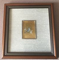 Framed artwork showing the full piece with a large matte and wooden frame