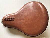 Top view of the smooth brown leather motorcycle saddle showing braided leather trim and accent.