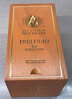 Top view of wooden cigar box with AVO logo and Preludio XO Serie Trio printed in black and gold with '25 Cigars' marking