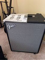 Front view of Fender Rumble 500 amplifier with owner's manual on top