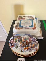 Photo showing Franklin Mint cat collector plates stacked with certificate and original packaging visible in background