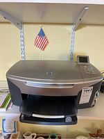 Full view of the HP Photosmart 2610xi all-in-one printer showing front paper tray and overall condition.