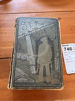 Front cover of 'Sea Tales' book with embossed maritime design and author name.