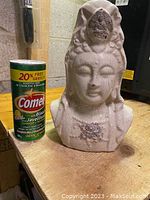 Front angle of the 12-inch Lady Buddha clay sculpture next to a can of Comet cleanser for scale, showing the white aged surface and details of the face and headdress.