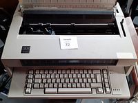Front view of IBM electric typewriter showing keyboard and IBM logo