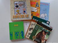 Seven assorted instructional drawing books laid out showing covers with cartoon and animal drawings.