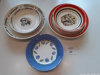 Two large serving size pasta bowls with names of pasta types around the rim and central Italian food illustration
