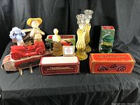 Full collection of vintage Avon collectible bottles, figurines, and decorative bottles on display.
