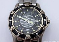 Front view of Fossil men's diver watch showing patterned black dial with luminous hands and markers, date window at 3 o'clock, and the 'blue' series marking.