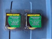Two new Weed Eater replacement spools in original packaging, labeled for XT400, PL200, 25HO SST models.