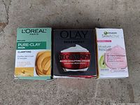 Photo of 3 skincare product boxes side by side: L'Oréal Paris Pure-Clay Mask, Olay Regenerist Micro-Sculpting Cream, Garnier SkinActive Moisture Rescue Gel-Cream