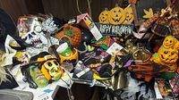 Overview of assorted Halloween and Thanksgiving items including masks, sign, dishes and decor on table